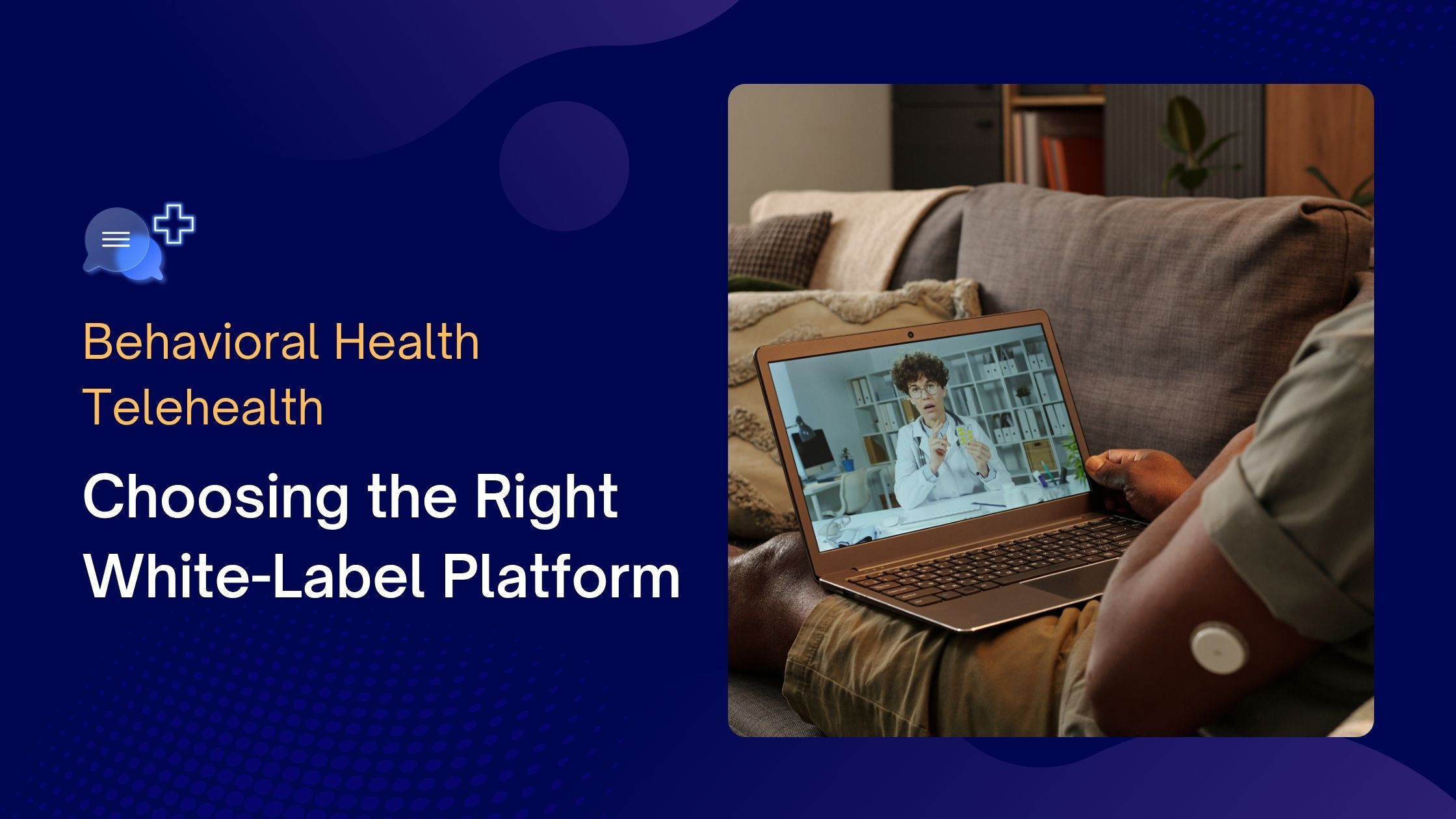 Side view of a person on their coach interacting with a therapist on a telehealth platform visible on their laptop screen.